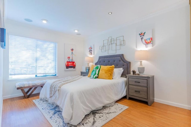 bedroom with ornamental molding and light wood-type flooring