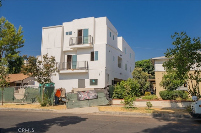 view of front of house with a balcony