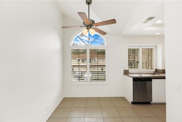 interior space featuring lofted ceiling, light tile patterned floors, sink, and ceiling fan