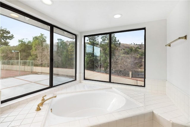 bathroom with tiled tub