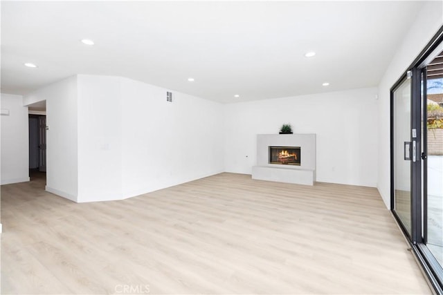 unfurnished living room with light wood-type flooring