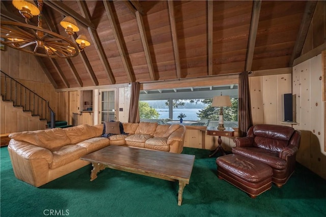 living room featuring wood walls, carpet, a notable chandelier, wooden ceiling, and beam ceiling