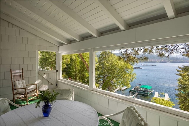 unfurnished sunroom with wood ceiling, lofted ceiling with beams, and a water view