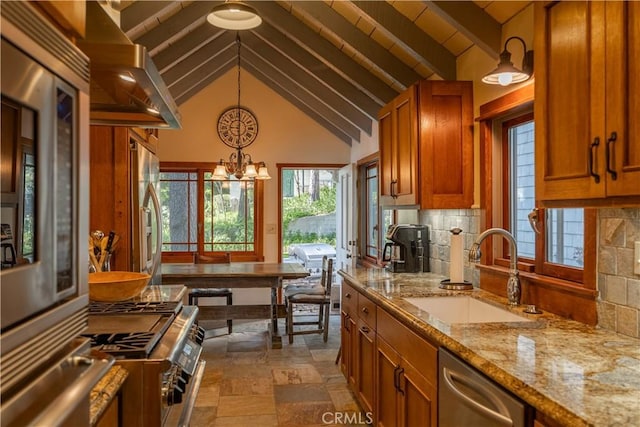 kitchen with sink, hanging light fixtures, beam ceiling, backsplash, and island exhaust hood