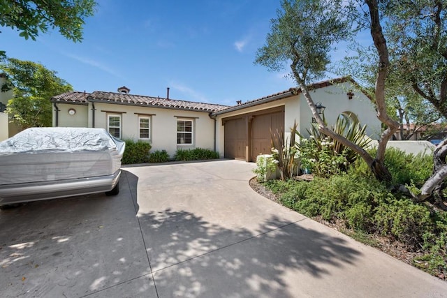 mediterranean / spanish home featuring a garage