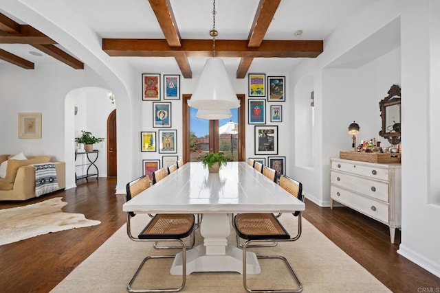 dining area featuring beamed ceiling, coffered ceiling, and dark hardwood / wood-style flooring