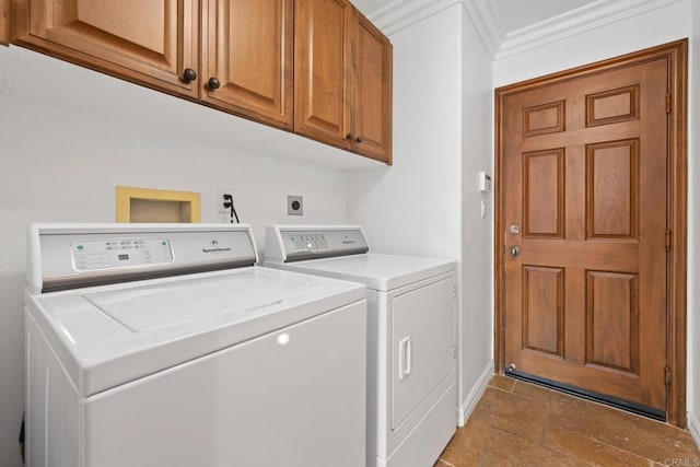 washroom with cabinets, ornamental molding, and separate washer and dryer