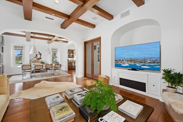 living room with coffered ceiling, beam ceiling, french doors, and hardwood / wood-style flooring