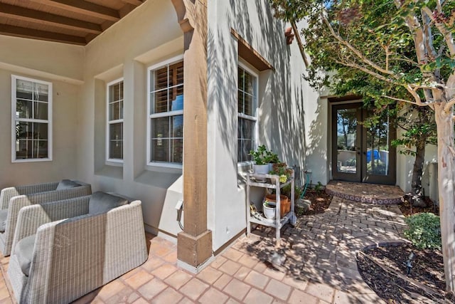 view of exterior entry featuring a patio area and french doors