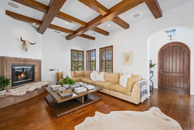 living room with coffered ceiling, a premium fireplace, dark hardwood / wood-style floors, and beam ceiling