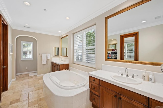 bathroom featuring crown molding, vanity, and a relaxing tiled tub