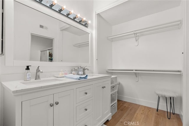 bathroom with vanity and hardwood / wood-style floors