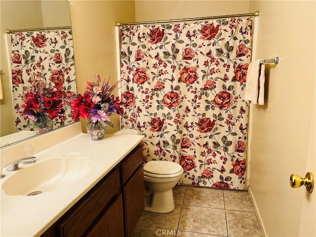 bathroom with vanity, tile patterned flooring, and toilet