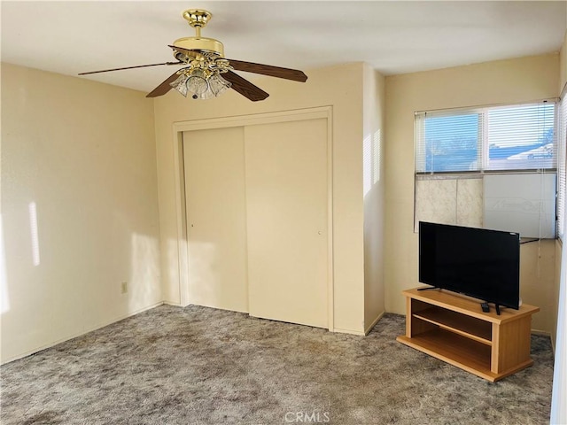 carpeted bedroom with a closet and ceiling fan