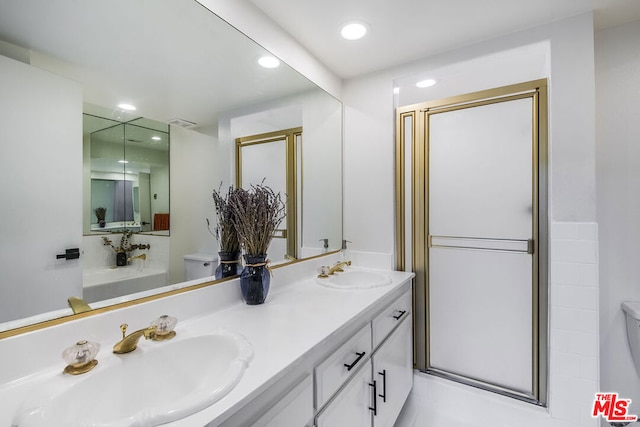 bathroom featuring vanity, toilet, and a shower with shower door