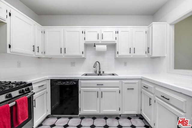 kitchen featuring black dishwasher, sink, and white cabinets