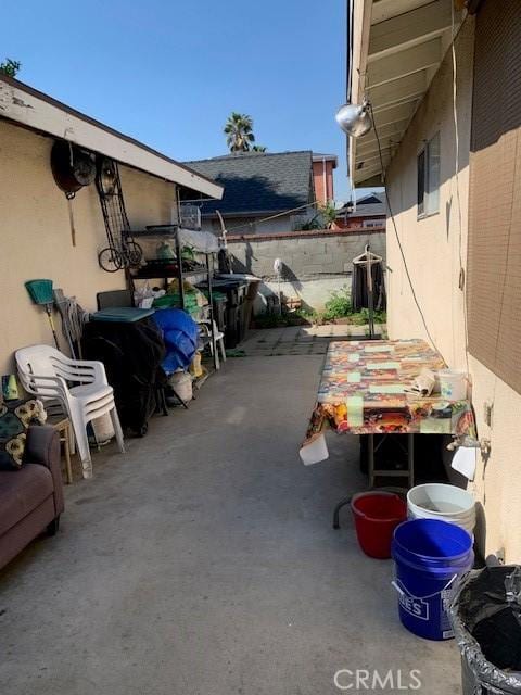 view of patio featuring fence