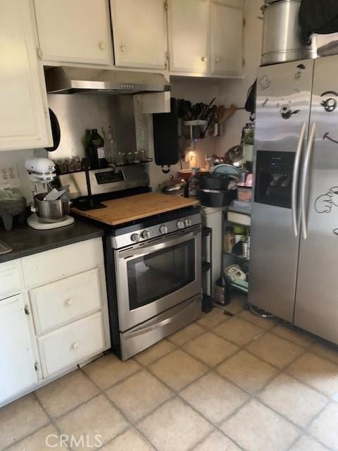 kitchen featuring white cabinets, dark countertops, appliances with stainless steel finishes, and under cabinet range hood