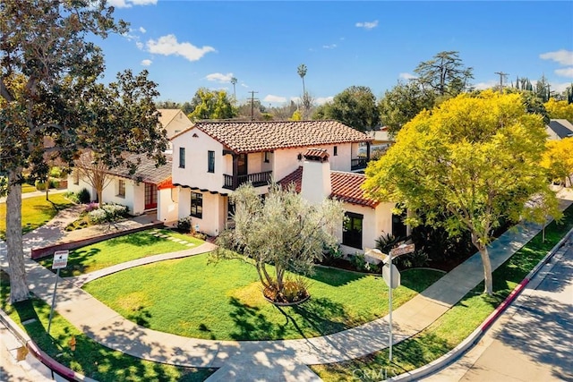 view of front of property with a front lawn and a balcony