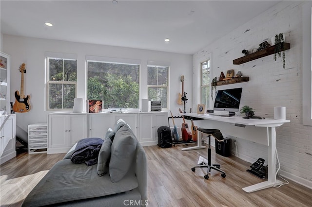 office space with a wealth of natural light and light hardwood / wood-style floors