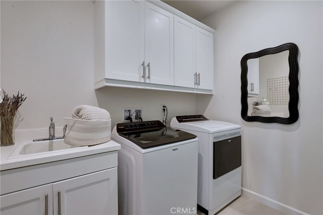 laundry room with cabinets, washer and dryer, and sink