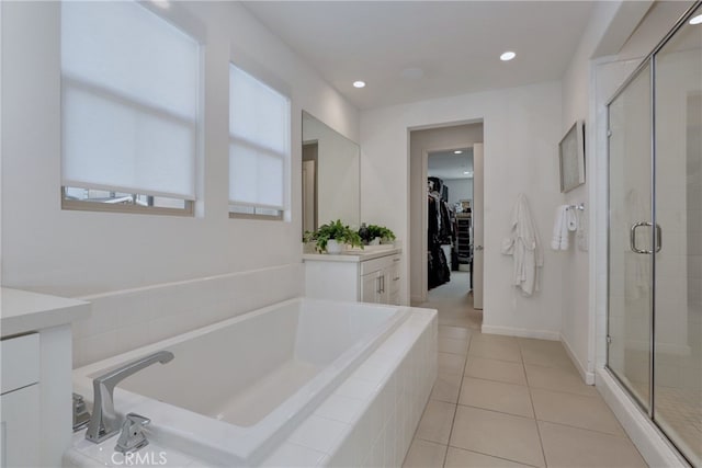 bathroom with shower with separate bathtub, tile patterned floors, and vanity