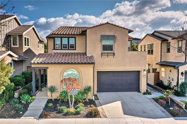 mediterranean / spanish-style house with a garage