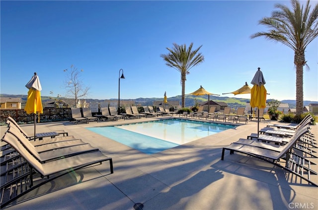 view of pool featuring a mountain view and a patio