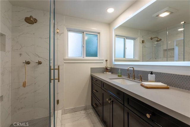 bathroom featuring an enclosed shower, vanity, and tasteful backsplash