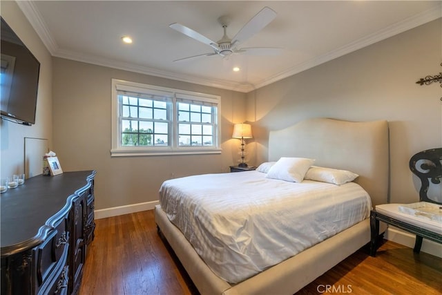 bedroom with crown molding, dark hardwood / wood-style floors, and ceiling fan