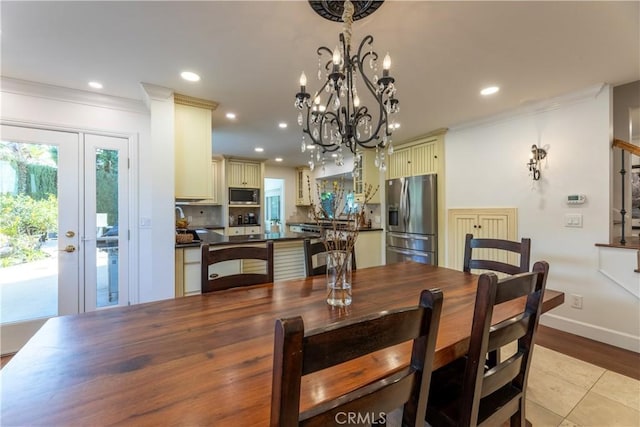 tiled dining space with crown molding and a chandelier