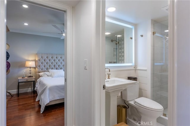 bathroom featuring wood-type flooring, toilet, ceiling fan, and walk in shower