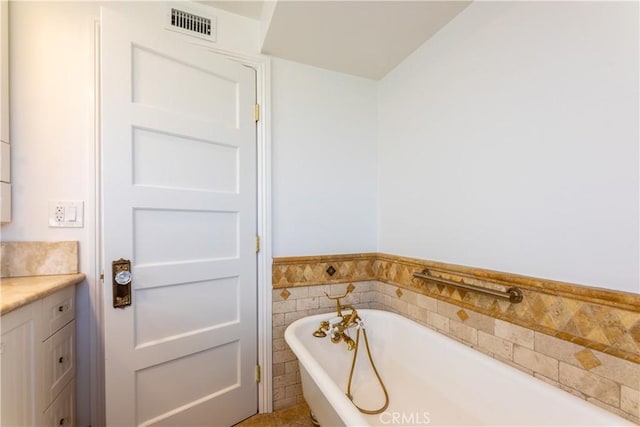 bathroom featuring vanity and a tub