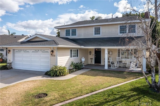 front of property featuring a garage, covered porch, and a front lawn