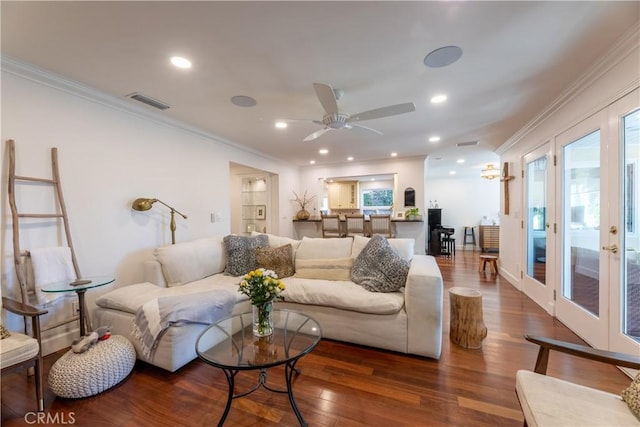 living room featuring crown molding, dark hardwood / wood-style floors, and ceiling fan