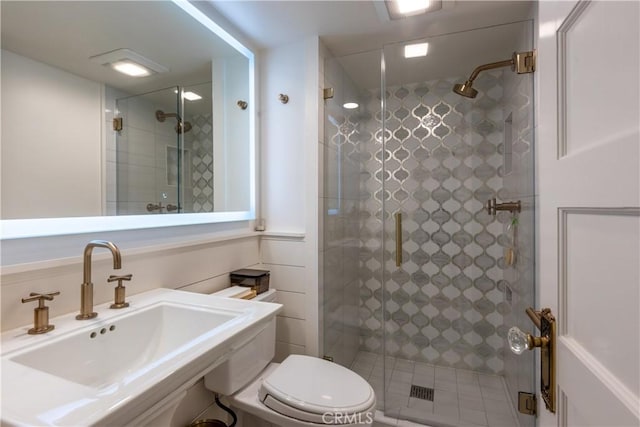 bathroom featuring sink, toilet, and walk in shower