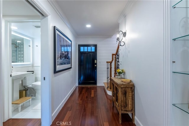 entryway with crown molding and hardwood / wood-style flooring