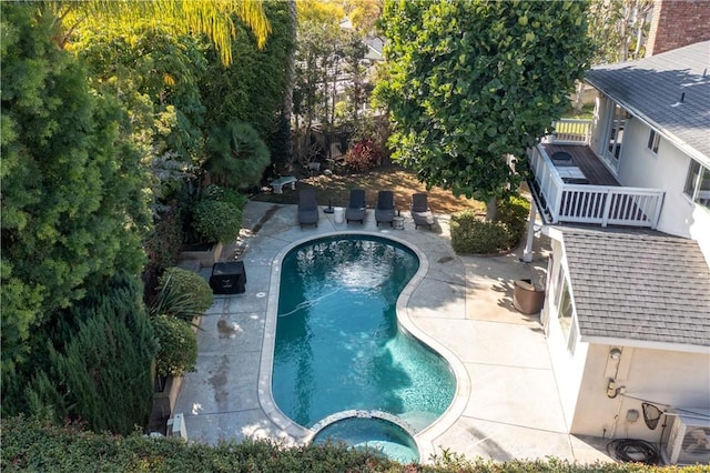 view of swimming pool with an in ground hot tub and a patio area