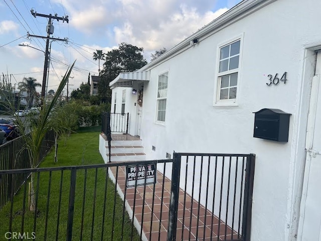 view of property exterior with a lawn