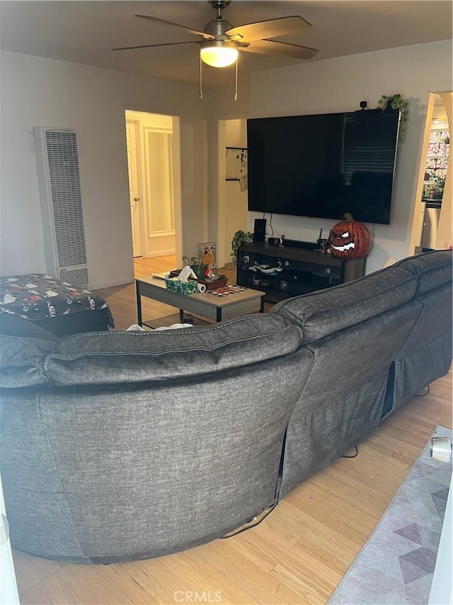 living room with hardwood / wood-style floors and ceiling fan