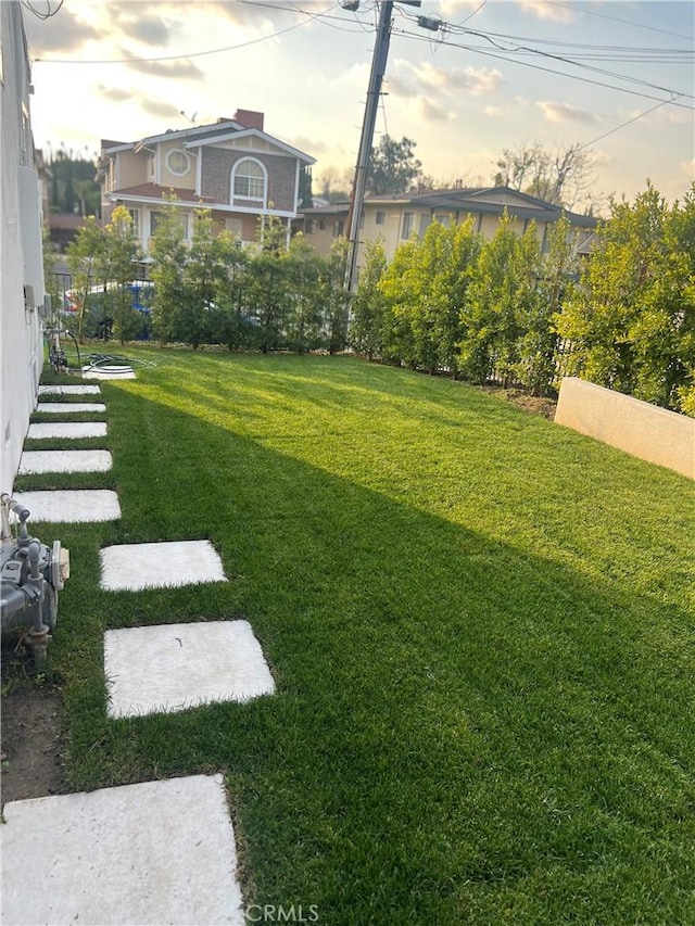 view of yard at dusk