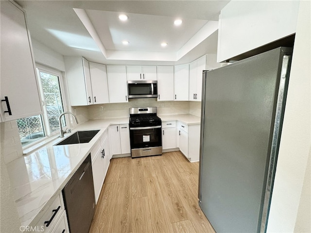 kitchen featuring white cabinetry, stainless steel appliances, and sink