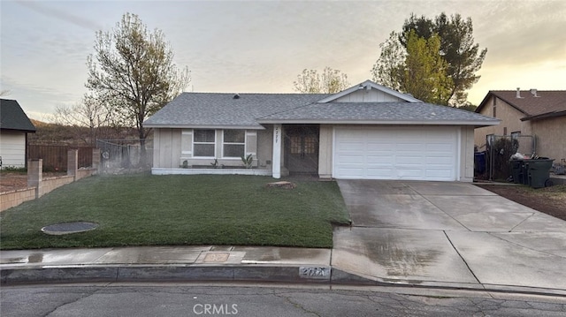 ranch-style house with a garage and a lawn