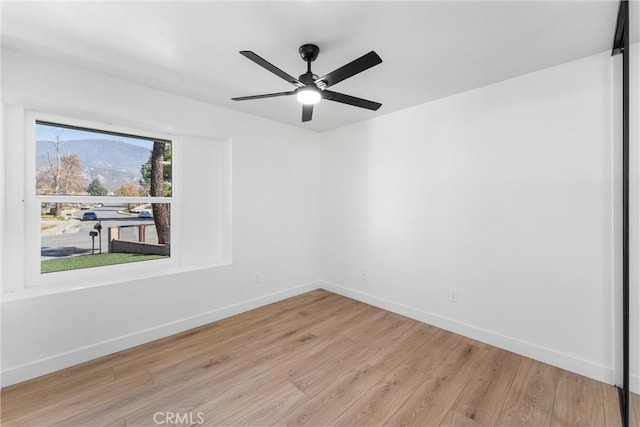 empty room featuring ceiling fan and light wood-type flooring