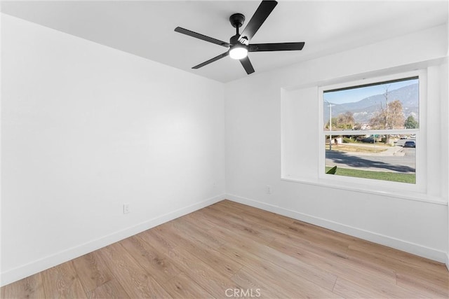 empty room with ceiling fan and light wood-type flooring