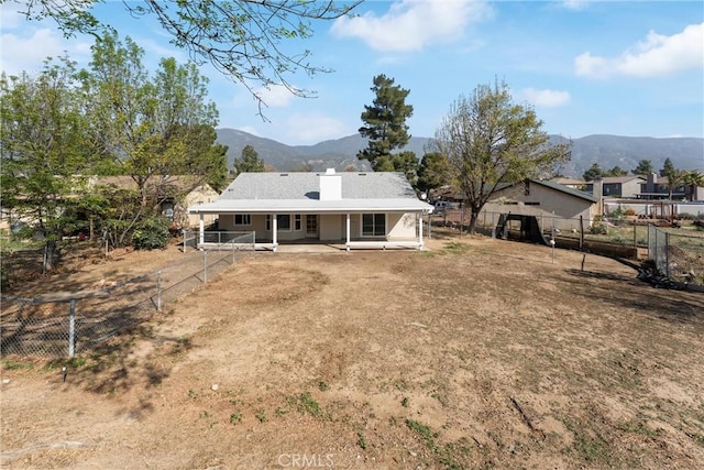 back of house featuring a patio and a mountain view