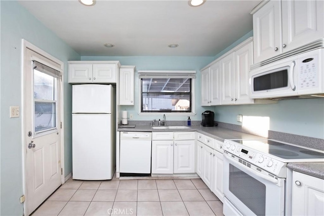 kitchen featuring white cabinetry, white appliances, sink, and light tile patterned floors