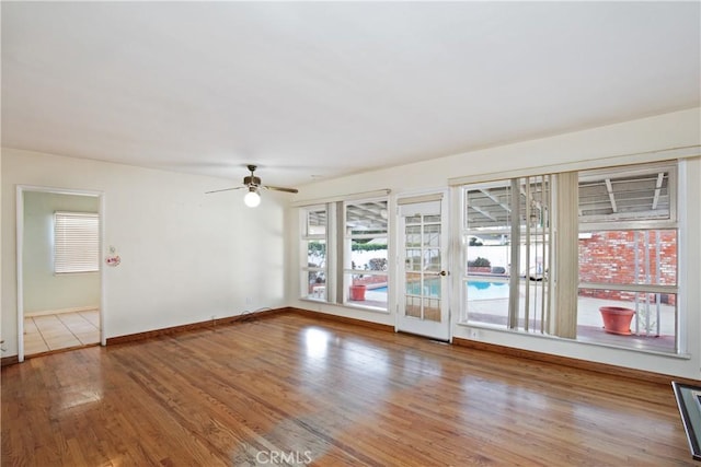 empty room with ceiling fan and light wood-type flooring