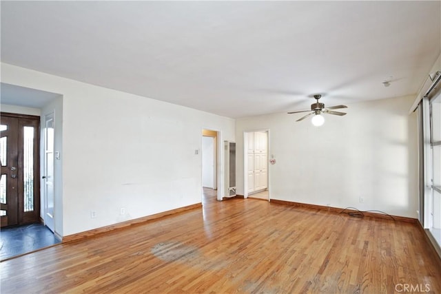 spare room with ceiling fan and light hardwood / wood-style floors