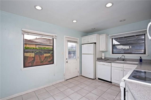 kitchen featuring sink, white appliances, light tile patterned floors, and white cabinets